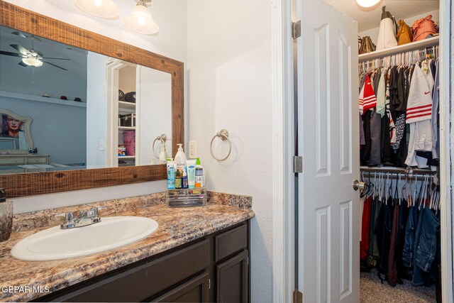 1321 Amber Morgan Dr, El Paso, TX 79936 - bathroom with vanity, a spacious closet, and a ceiling fan