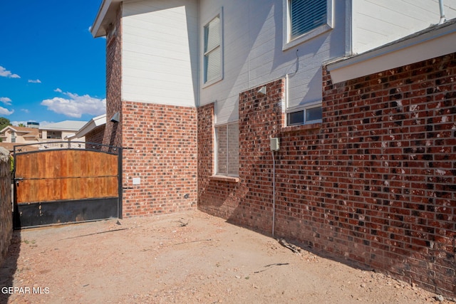 1321 Amber Morgan Dr, El Paso, TX 79936 - view of home's exterior with brick siding and a gate