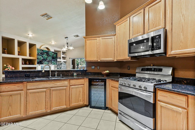 658 John Martin Ct, El Paso, TX 79932 - kitchen with appliances with stainless steel finishes, beverage cooler, a sink, light brown cabinetry, and light tile patterned flooring