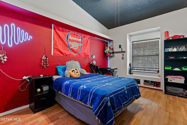658 John Martin Ct, El Paso, TX 79932 - bedroom featuring wood finished floors and vaulted ceiling