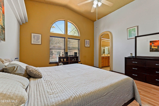 658 John Martin Ct, El Paso, TX 79932 - bedroom featuring arched walkways, light wood-style floors, lofted ceiling, and connected bathroom