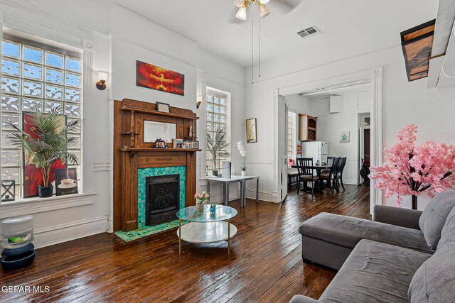 712 N Ochoa St, El Paso, TX 79902 - living room with hardwood / wood-style flooring, ceiling fan, a premium fireplace, and baseboards