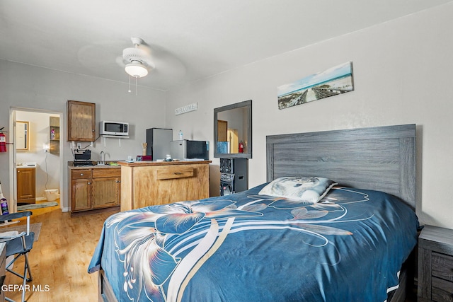712 N Ochoa St, El Paso, TX 79902 - bedroom featuring light wood-style flooring and a sink