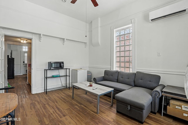 712 N Ochoa St, El Paso, TX 79902 - living room with ceiling fan, an AC wall unit, and wood finished floors