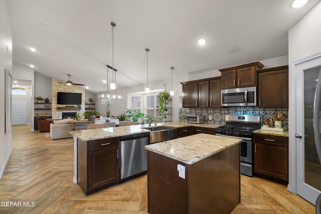 14183 Peyton Edwards Ave, El Paso, TX 79938 - kitchen with appliances with stainless steel finishes, a sink, a peninsula, dark brown cabinets, and decorative backsplash