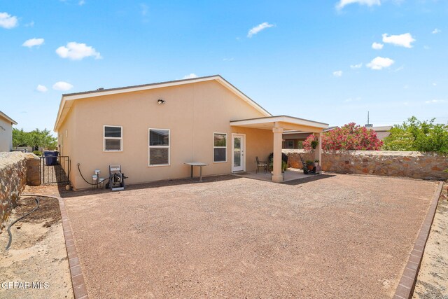 14183 Peyton Edwards Ave, El Paso, TX 79938 - back of property with stucco siding, a patio, and a gate
