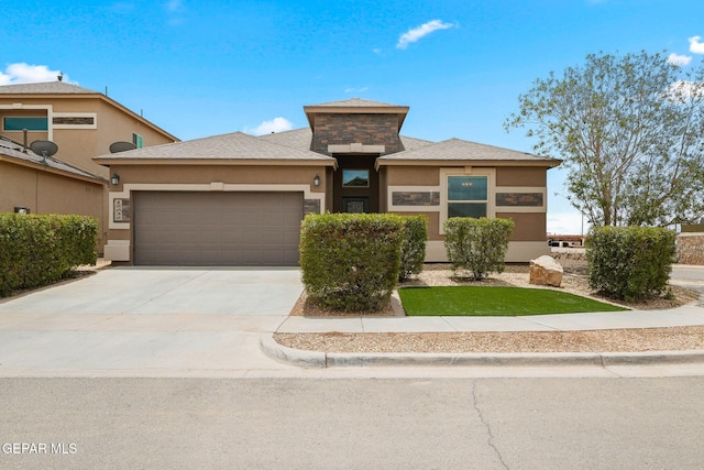 12632 Katherine Brennand Rd, El Paso, TX 79928 - prairie-style house featuring an attached garage, stucco siding, and concrete driveway