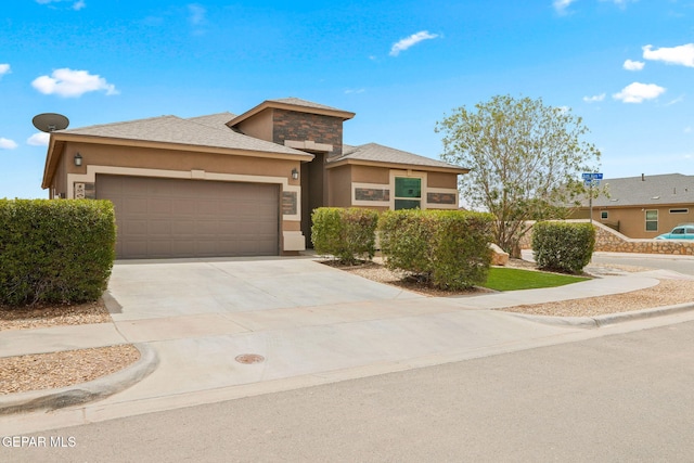 12632 Katherine Brennand Rd, El Paso, TX 79928 - view of front facade with a garage, stucco siding, driveway, and stone siding