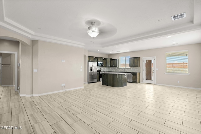 12632 Katherine Brennand Rd, El Paso, TX 79928 - kitchen featuring appliances with stainless steel finishes, open floor plan, ceiling fan, a tray ceiling, and recessed lighting