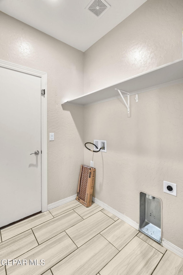 12632 Katherine Brennand Rd, El Paso, TX 79928 - washroom featuring hookup for a washing machine, wood tiled floors, baseboards, and hookup for an electric dryer