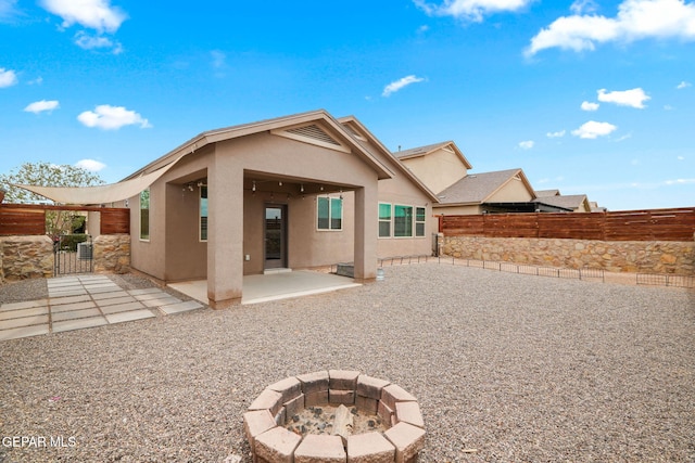 12632 Katherine Brennand Rd, El Paso, TX 79928 - back of property featuring stucco siding, a patio, a fenced backyard, and an outdoor fire pit