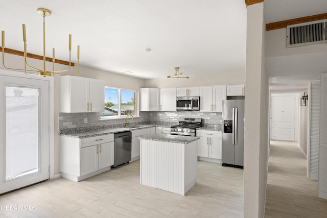 4317 Larchmont Dr, El Paso, TX 79902 - kitchen with stainless steel appliances, backsplash, and light stone counters