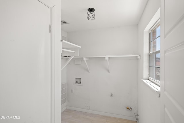 4317 Larchmont Dr, El Paso, TX 79902 - laundry room featuring hookup for a gas dryer, wood finished floors, hookup for a washing machine, and baseboards