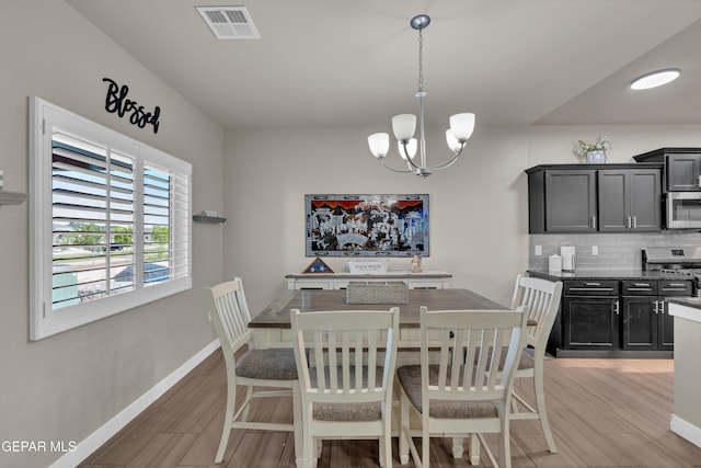 2401 Mike Price Dr, El Paso, TX 79938 - dining room with a chandelier, baseboards, and light wood-type flooring