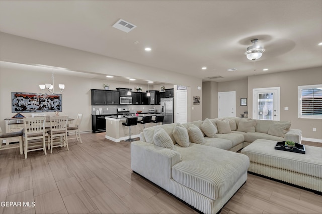 2401 Mike Price Dr, El Paso, TX 79938 - living area with a chandelier, recessed lighting, wood tiled floors, baseboards, and ceiling fan