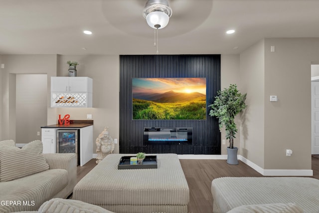 2401 Mike Price Dr, El Paso, TX 79938 - living area featuring a glass covered fireplace, wood finished floors, bar, baseboards, and wine cooler