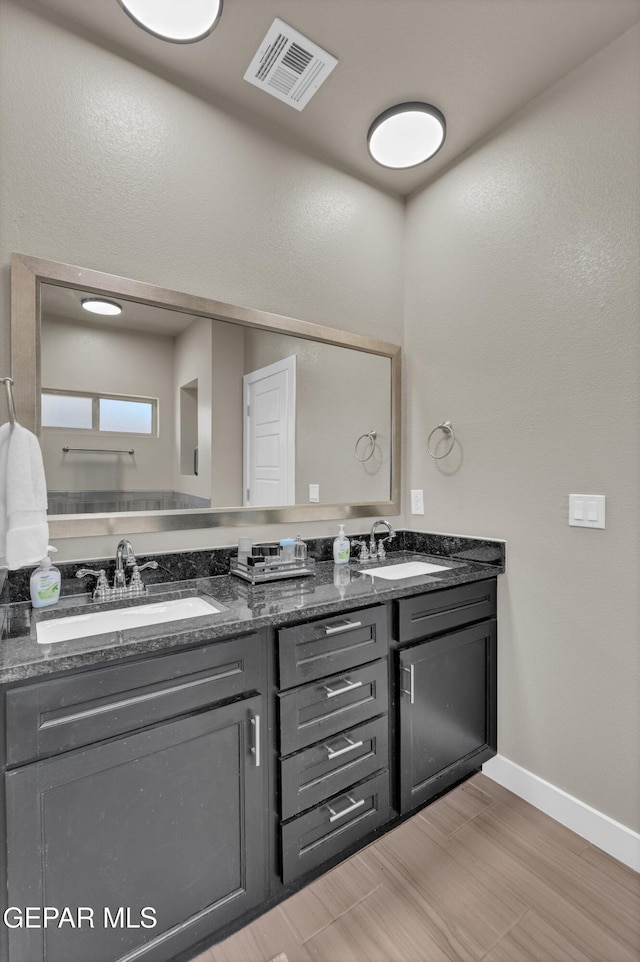 2401 Mike Price Dr, El Paso, TX 79938 - bathroom with double vanity, baseboards, and wood finished floors