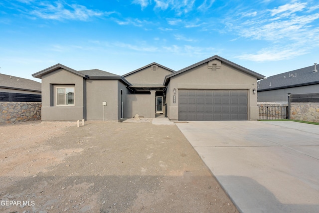 2401 Mike Price Dr, El Paso, TX 79938 - single story home featuring an attached garage, stucco siding, and driveway