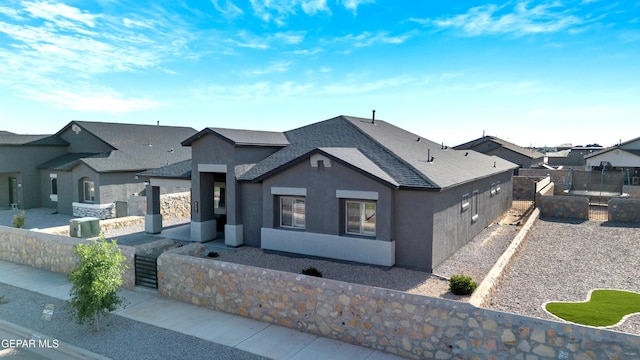2401 Mike Price Dr, El Paso, TX 79938 - view of front of home with stucco siding, a shingled roof, and a residential view