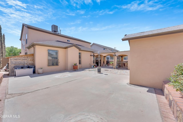 444 Ghost Flower St, Horizon City, TX 79928 - back of property with stucco siding and a patio area