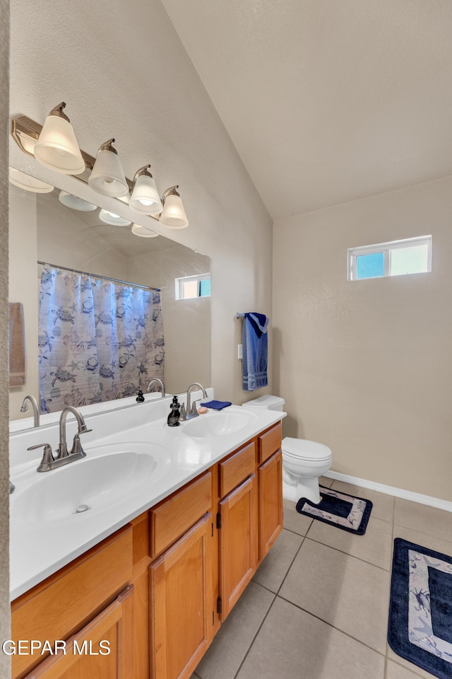444 Ghost Flower St, Horizon City, TX 79928 - full bath featuring lofted ceiling, double vanity, tile patterned flooring, and curtained shower