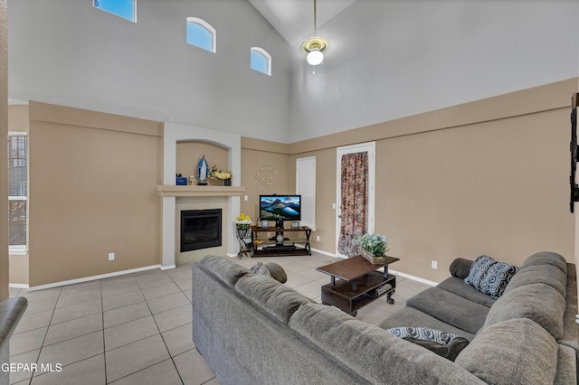 444 Ghost Flower St, Horizon City, TX 79928 - living room with high vaulted ceiling, tile patterned floors, and a fireplace