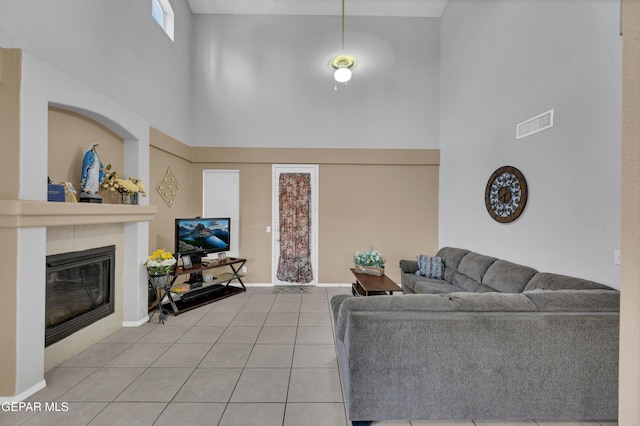 444 Ghost Flower St, Horizon City, TX 79928 - tiled living room featuring a high ceiling and a tile fireplace