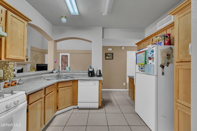 444 Ghost Flower St, Horizon City, TX 79928 - kitchen with white appliances, light tile patterned floors, light countertops, backsplash, and light brown cabinetry