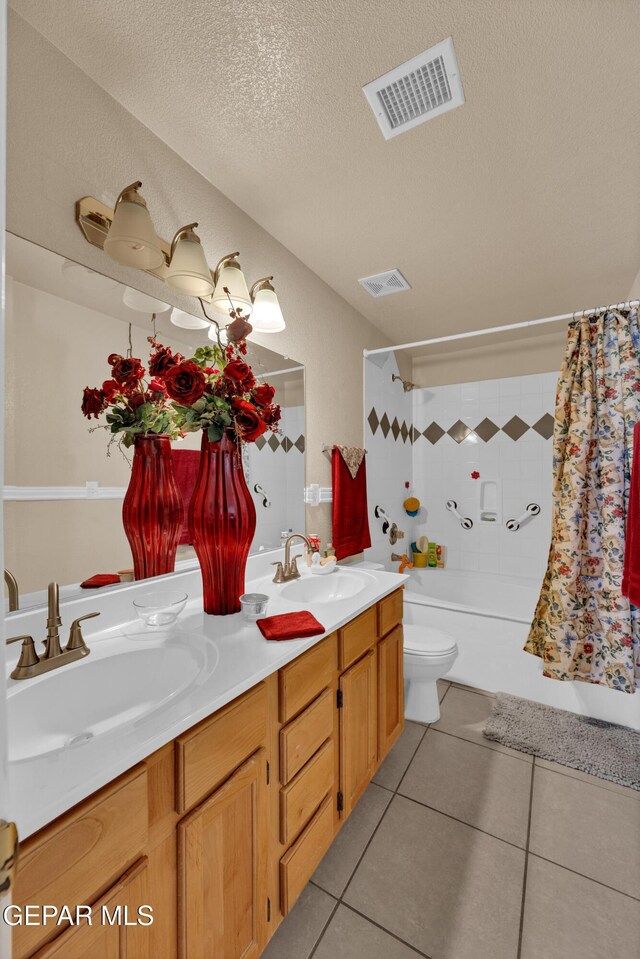 444 Ghost Flower St, Horizon City, TX 79928 - bathroom featuring double vanity, shower / tub combo, a textured ceiling, and tile patterned floors