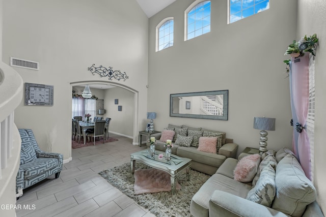 12416 Paseo Largo Cir, El Paso, TX 79928 - living area with high vaulted ceiling, arched walkways, and baseboards
