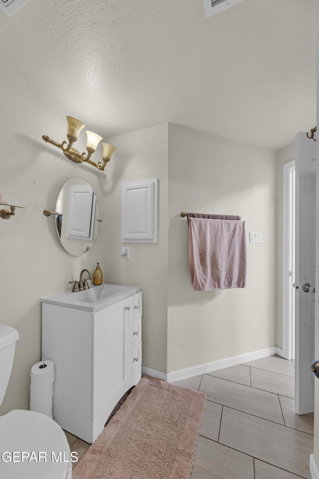 12416 Paseo Largo Cir, El Paso, TX 79928 - half bathroom featuring vanity, toilet, and a textured ceiling