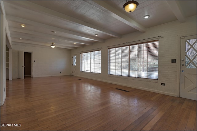 5140 Camino De La Vista Dr, El Paso, TX 79932 - entryway featuring brick wall, plenty of natural light, wood-type flooring, baseboards, and beam ceiling