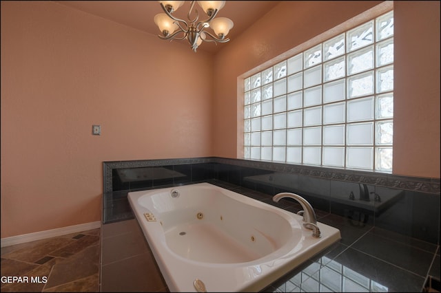 5140 Camino De La Vista Dr, El Paso, TX 79932 - full bath with a chandelier, a tub with jets, baseboards, and lofted ceiling