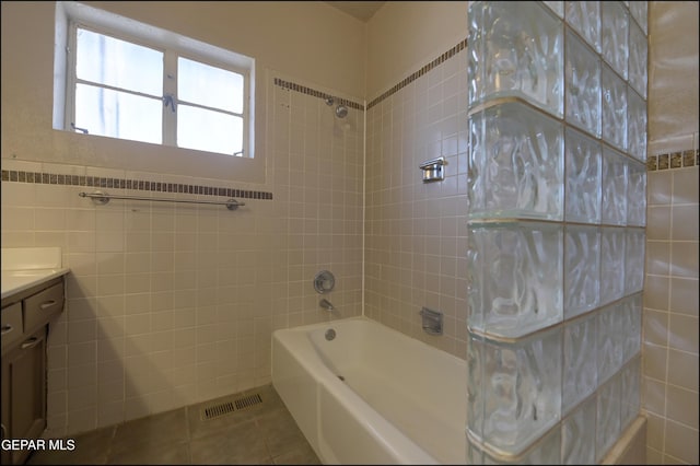 5140 Camino De La Vista Dr, El Paso, TX 79932 - bathroom featuring tile patterned floors, vanity, tile walls, and washtub / shower combination