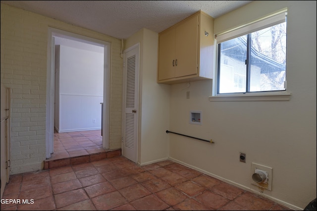 5140 Camino De La Vista Dr, El Paso, TX 79932 - laundry area featuring hookup for an electric dryer, washer hookup, cabinet space, a textured ceiling, and baseboards
