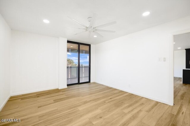 1800 N Stanton St Unit 603, El Paso, TX 79902 - spare room featuring ceiling fan, expansive windows, light wood-style floors, recessed lighting, and baseboards