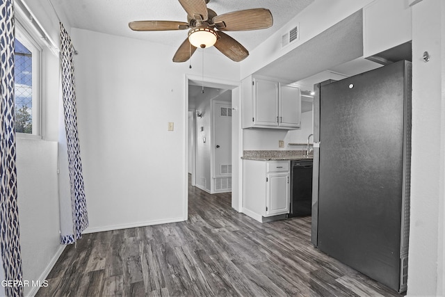 4745 Sierra Madre Dr, El Paso, TX 79904 - kitchen with freestanding refrigerator, white cabinetry, black dishwasher, dark wood-style floors, and ceiling fan