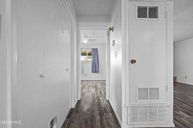 4745 Sierra Madre Dr, El Paso, TX 79904 - hallway with a textured ceiling, dark wood finished floors, and baseboards
