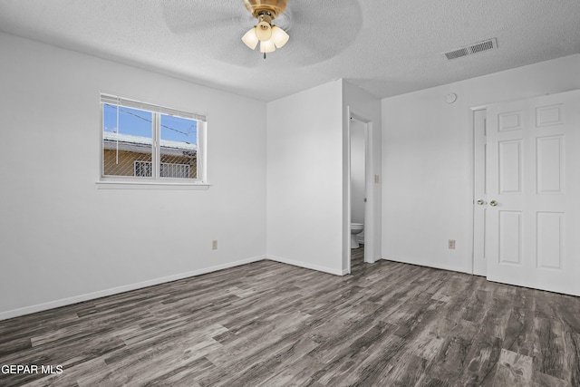 4745 Sierra Madre Dr, El Paso, TX 79904 - unfurnished bedroom with wood finished floors, a textured ceiling, baseboards, and a ceiling fan
