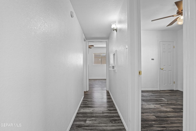 4745 Sierra Madre Dr, El Paso, TX 79904 - hallway with dark wood finished floors, baseboards, and a textured wall