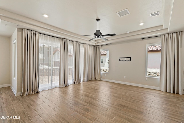 2352 Kolt Ct, El Paso, TX 79911 - unfurnished room with ceiling fan, baseboards, light wood-type flooring, and a raised ceiling