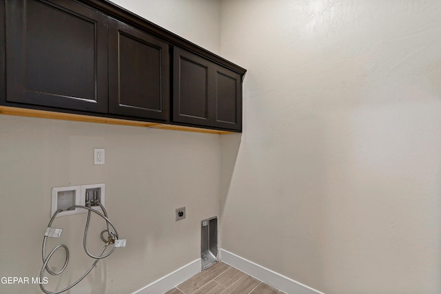 2352 Kolt Ct, El Paso, TX 79911 - washroom with washer hookup, cabinet space, electric dryer hookup, baseboards, and light wood finished floors