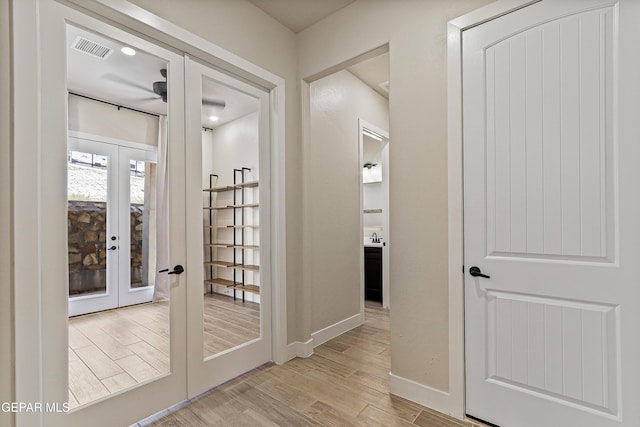 2352 Kolt Ct, El Paso, TX 79911 - hall with french doors, light wood finished floors, and baseboards
