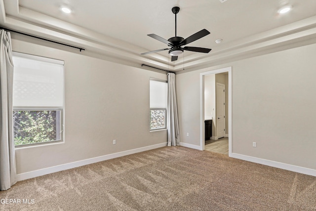 2352 Kolt Ct, El Paso, TX 79911 - empty room with a tray ceiling, light colored carpet, a ceiling fan, baseboards, and recessed lighting