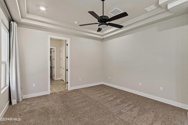 2352 Kolt Ct, El Paso, TX 79911 - empty room featuring a raised ceiling, carpet floors, ceiling fan, and baseboards