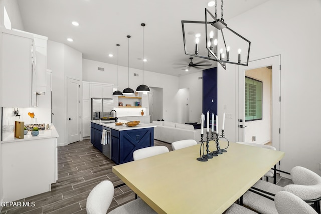 1449 Indigo Sky St, El Paso, TX 79928 - kitchen with blue cabinetry, a ceiling fan, light countertops, white cabinets, and a kitchen island with sink