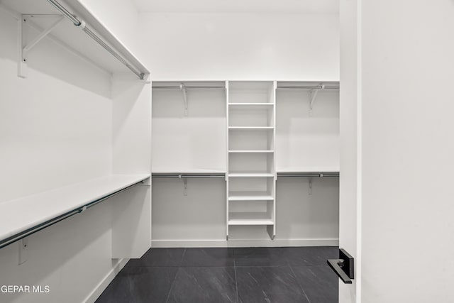 1449 Indigo Sky St, El Paso, TX 79928 - spacious closet featuring dark tile patterned floors