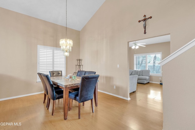 6800 Canyon Run Dr, El Paso, TX 79912 - dining area featuring high vaulted ceiling, wood finished floors, ceiling fan, a chandelier, and baseboards