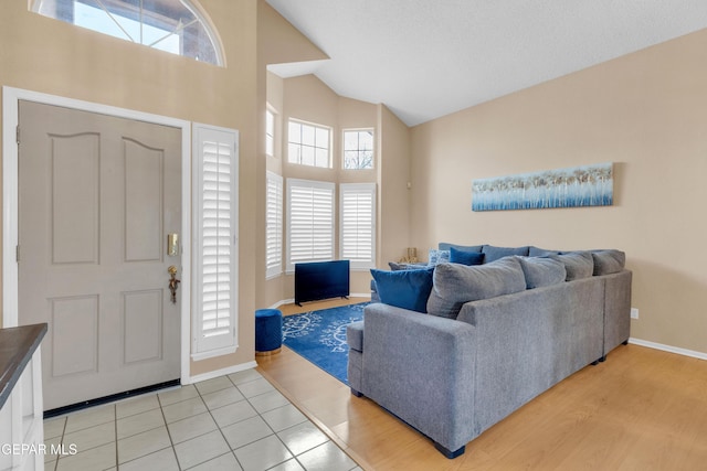 6800 Canyon Run Dr, El Paso, TX 79912 - foyer with high vaulted ceiling, baseboards, and light wood-style floors