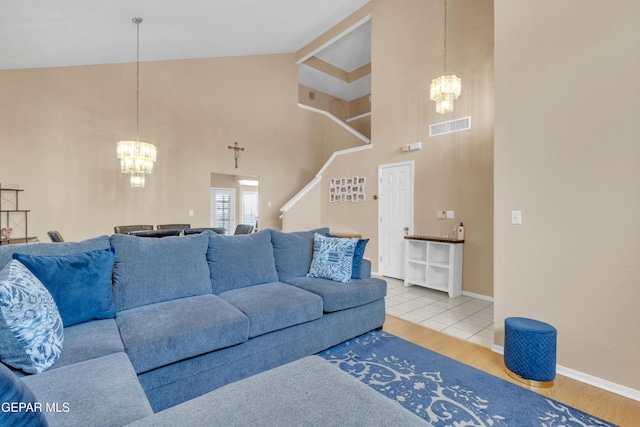 6800 Canyon Run Dr, El Paso, TX 79912 - living area featuring a chandelier, wood finished floors, high vaulted ceiling, baseboards, and stairs